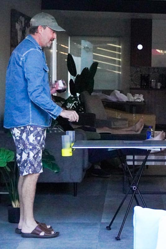A grown man playing beer pong on taktables